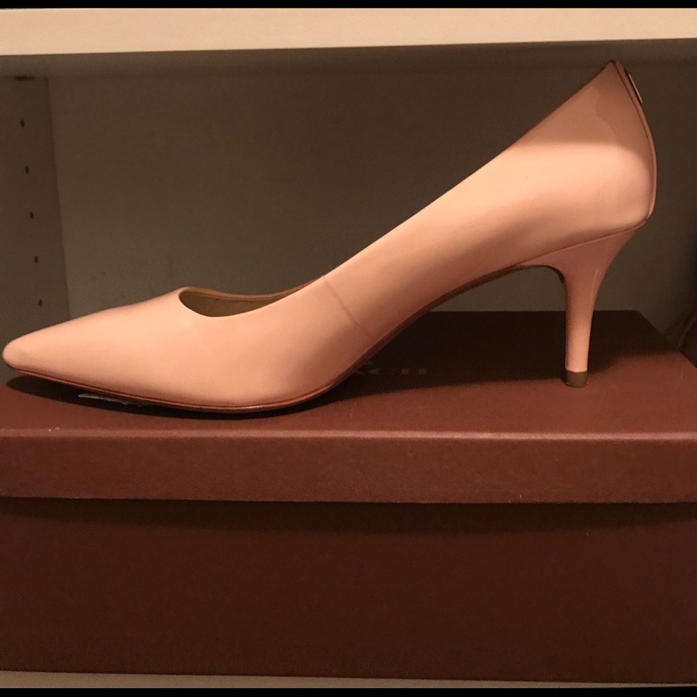 Light pink Coach low heel pumps.